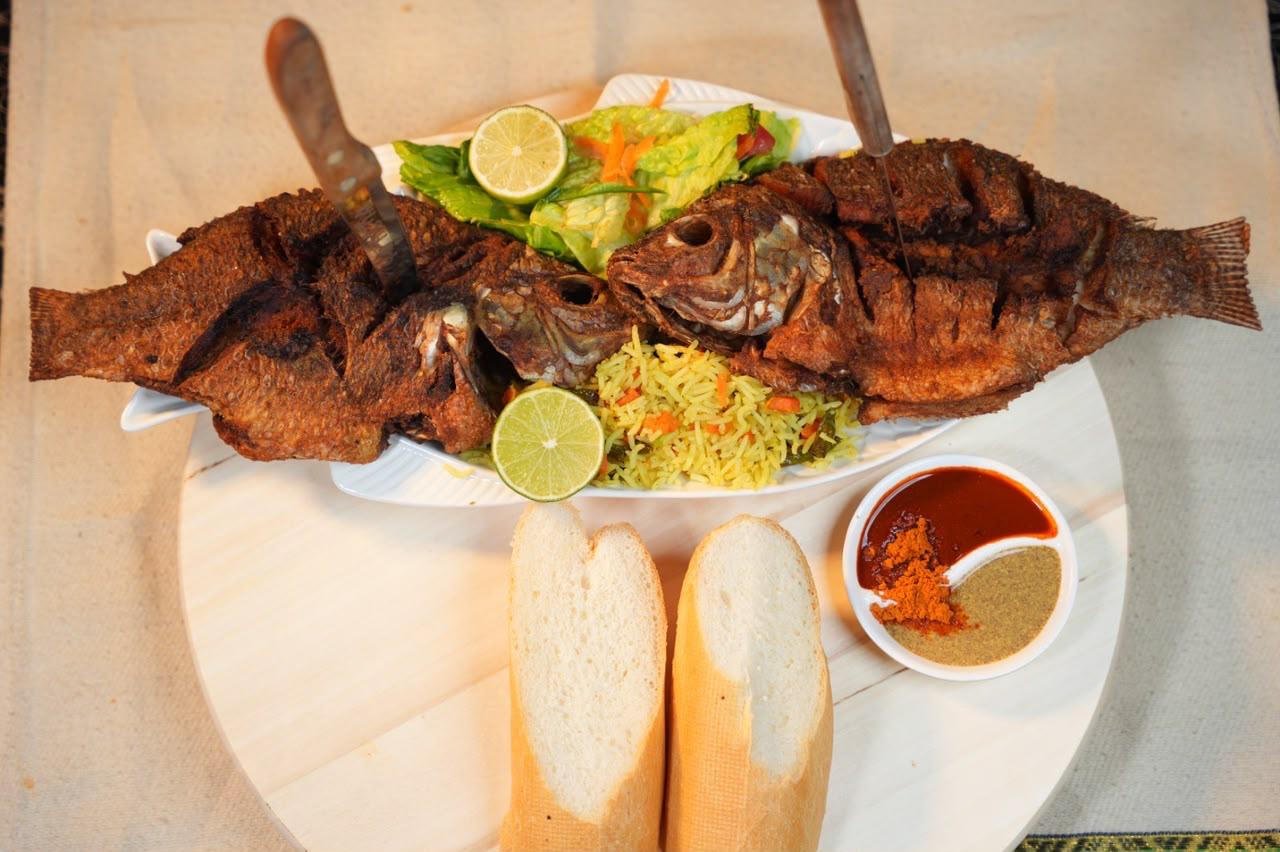 Whole fish with salad, injera and sauce