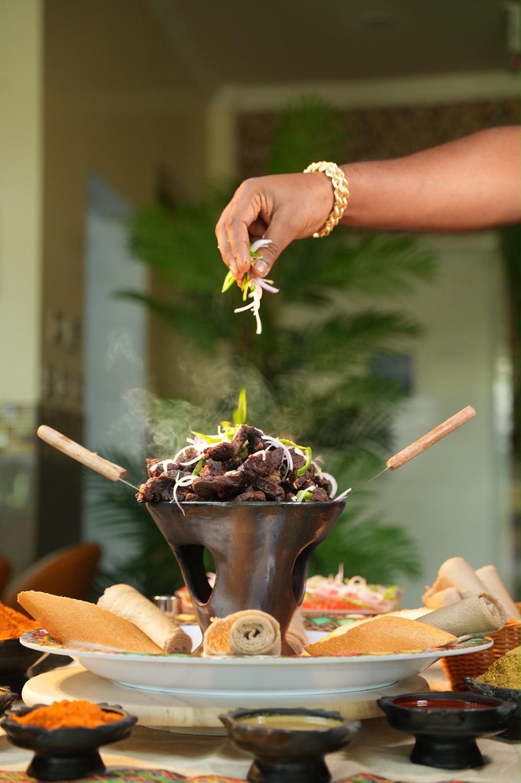 A hot dish being served at the table
